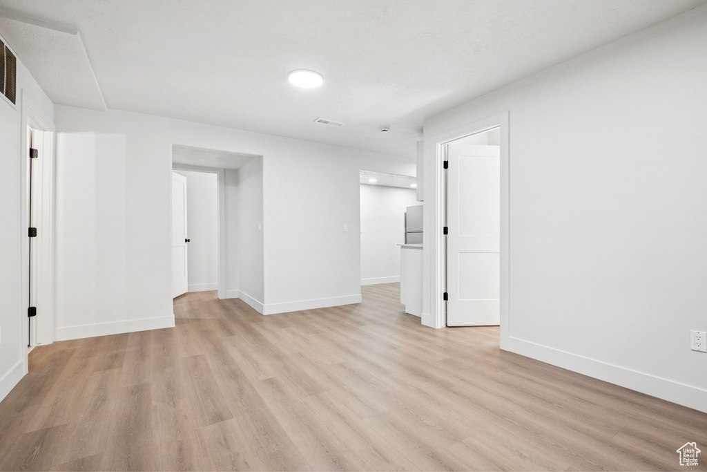 Empty room featuring light wood-style flooring and baseboards