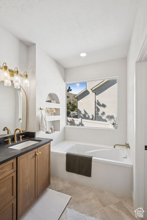 Full bathroom with a bath and vanity