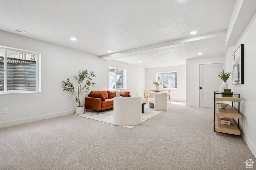 Living room featuring carpet floors, recessed lighting, and a textured ceiling