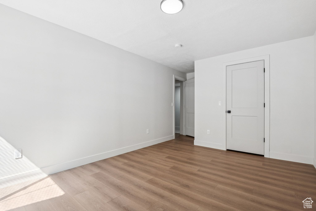 Unfurnished bedroom featuring light wood-style floors and baseboards