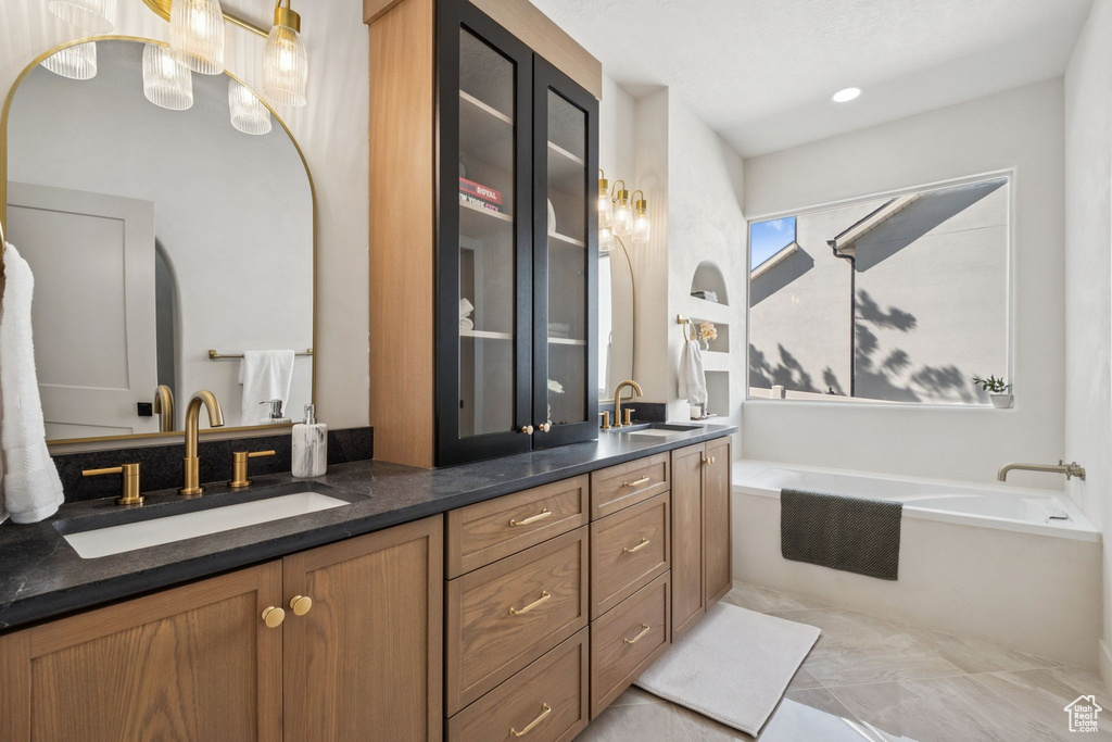 Bathroom featuring double vanity and a garden tub