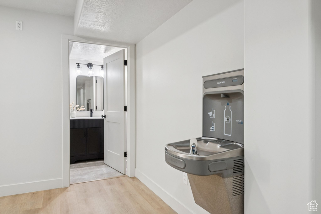 Bathroom with wood finished floors and vanity
