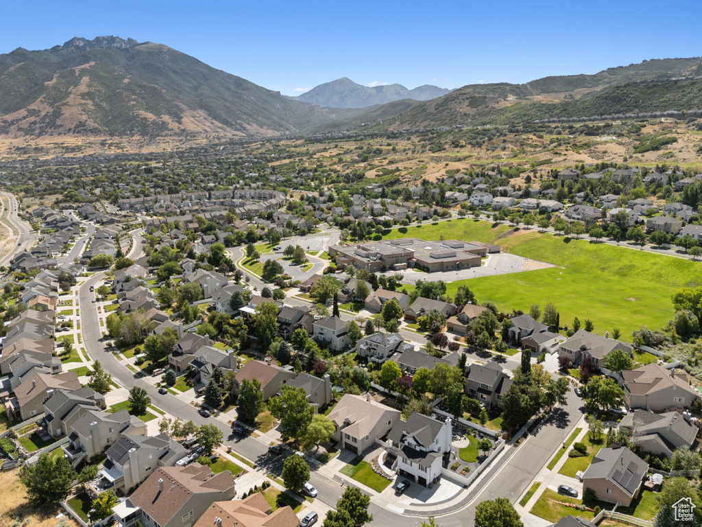Aerial overview of property\'s location featuring mountains and nearby suburban area
