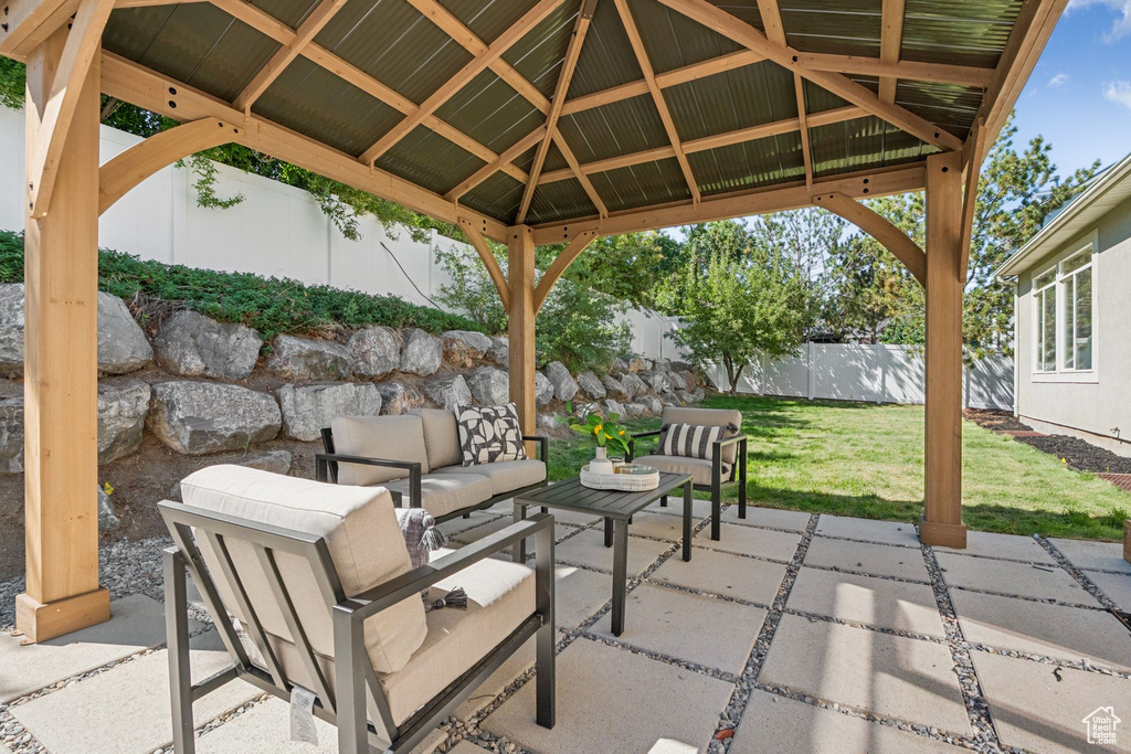Fenced backyard with a gazebo, a patio area, and an outdoor living space