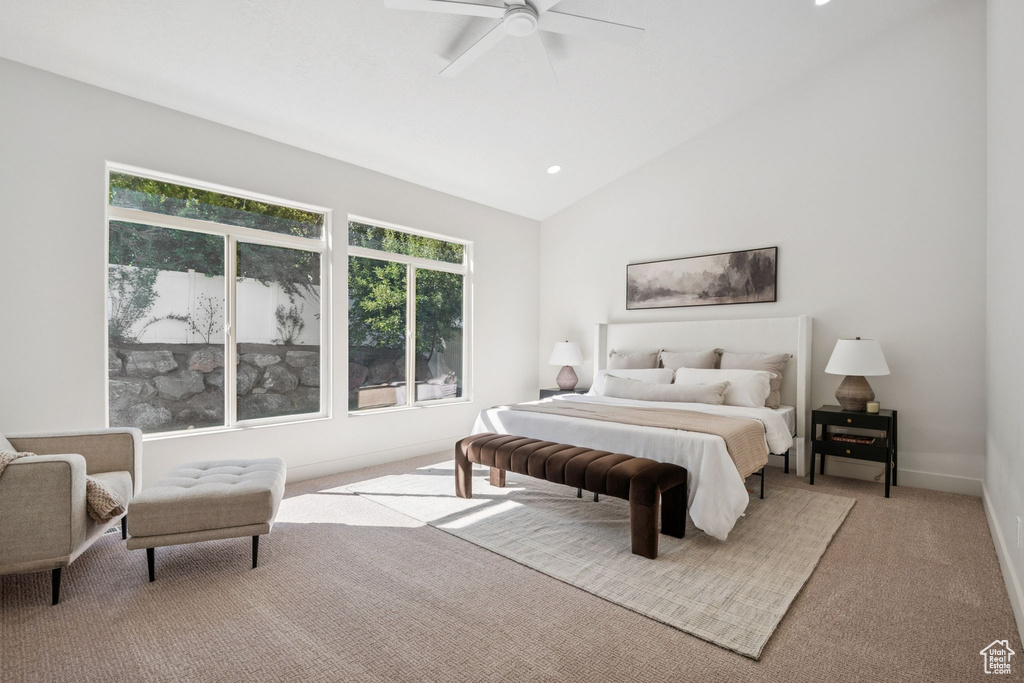 Carpeted bedroom with lofted ceiling and a ceiling fan