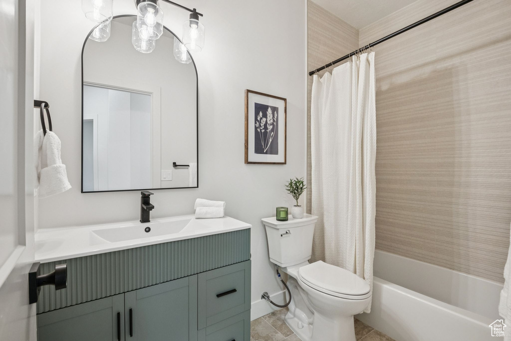 Full bathroom with vanity, shower / tub combo with curtain, and tile patterned flooring
