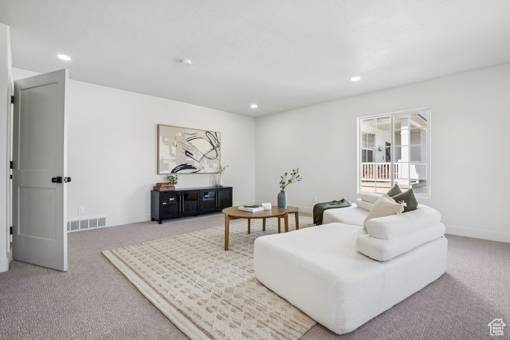 Living area featuring carpet floors and recessed lighting