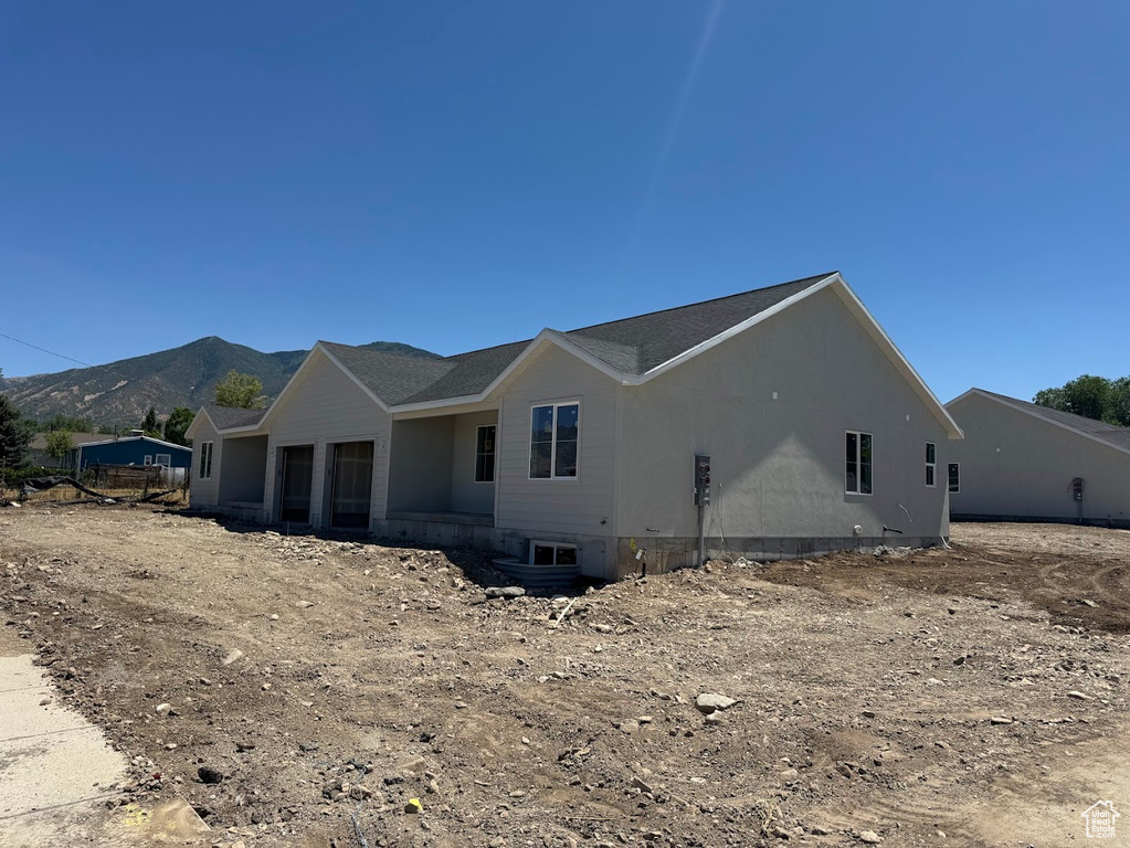 View of side of property with a mountain view