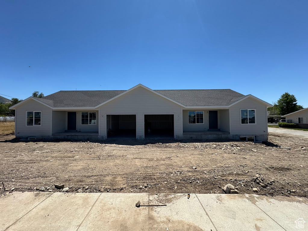 View of front facade with an attached garage and covered porch