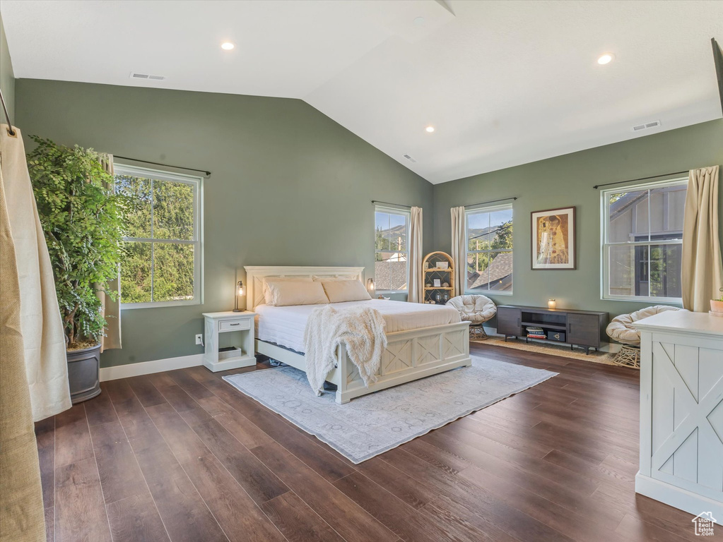 Bedroom with lofted ceiling, dark wood-type flooring, multiple windows, and recessed lighting