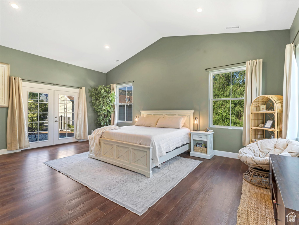 Bedroom featuring access to outside, french doors, vaulted ceiling, multiple windows, and dark wood-style flooring