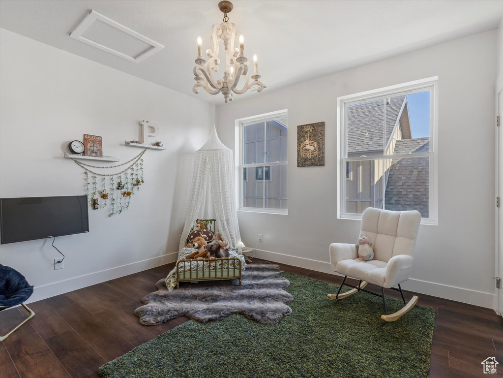 Sitting room with wood finished floors and attic access