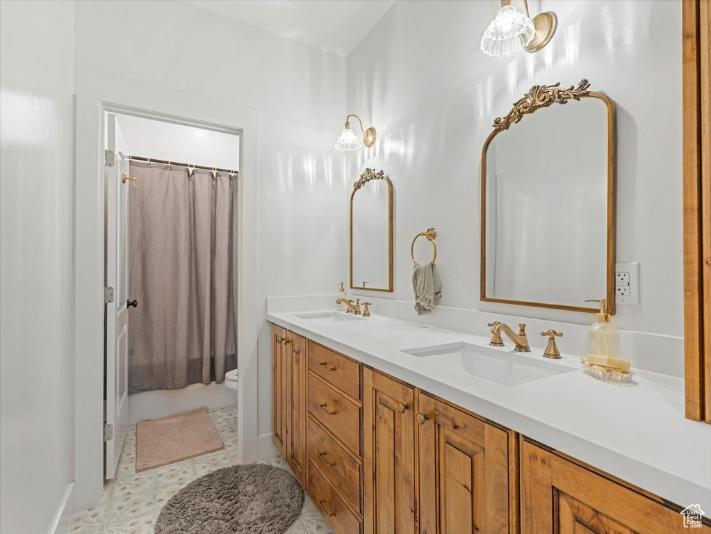 Full bathroom featuring double vanity and shower / bath combination with curtain