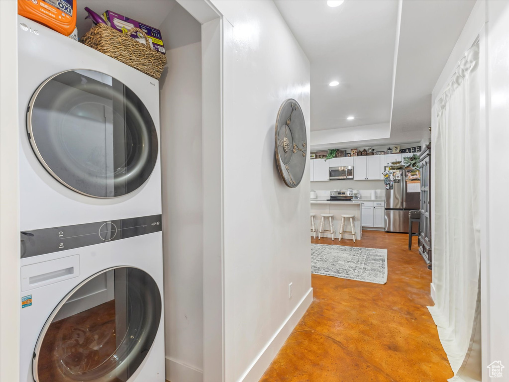 Laundry area with stacked washer / dryer and recessed lighting