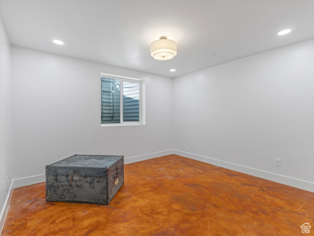 Spare room featuring concrete flooring and recessed lighting