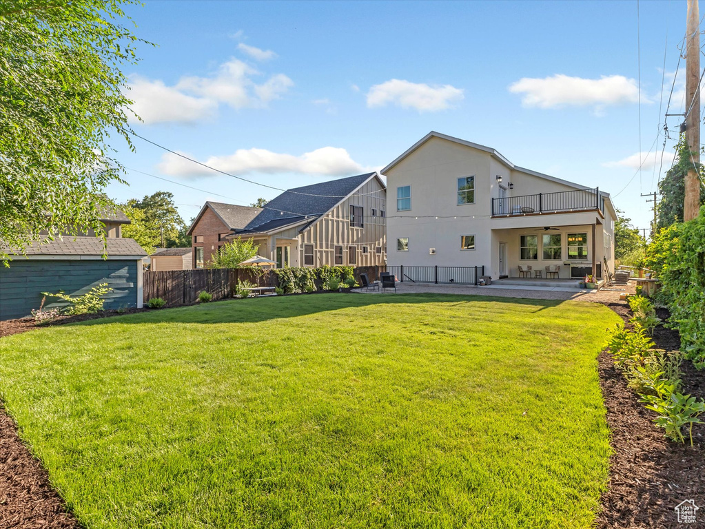 Rear view of house with a patio, a ceiling fan, a fenced backyard, and stucco siding