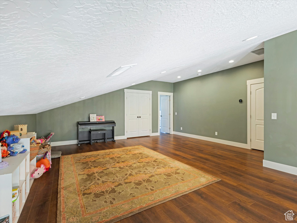 Bonus room featuring wood finished floors, recessed lighting, vaulted ceiling, and a textured ceiling