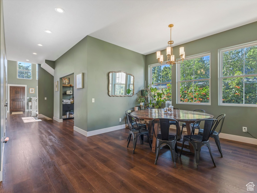 Dining room with a chandelier, dark wood-type flooring, and recessed lighting