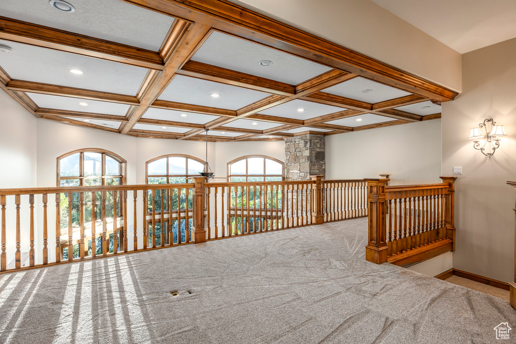 Spare room with coffered ceiling, carpet, beamed ceiling, recessed lighting, and healthy amount of natural light