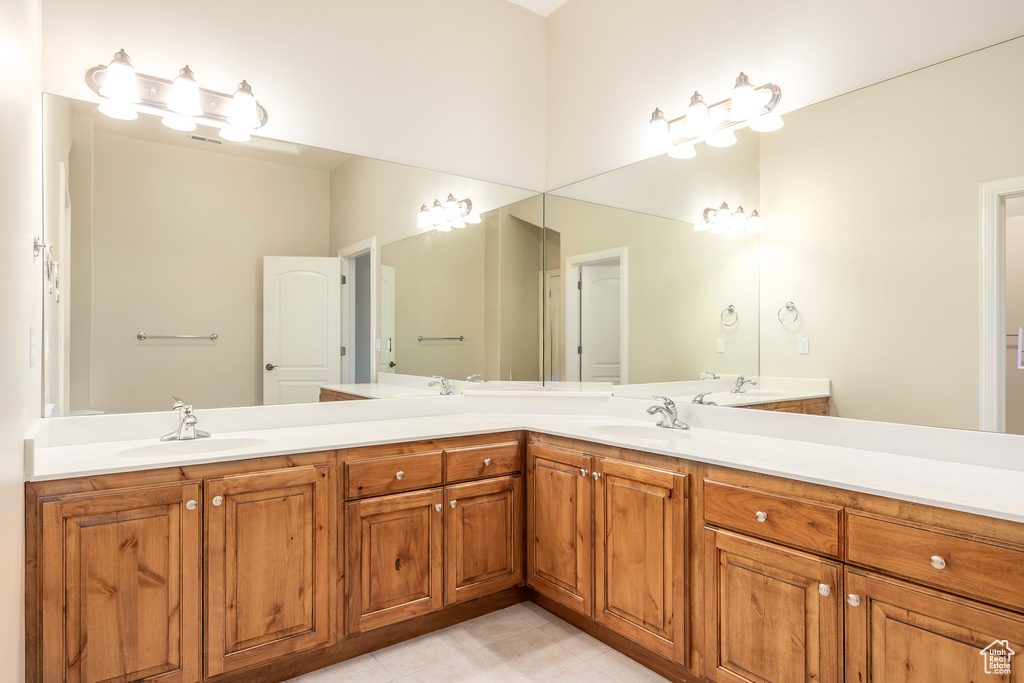 Bathroom featuring double vanity and tile patterned floors