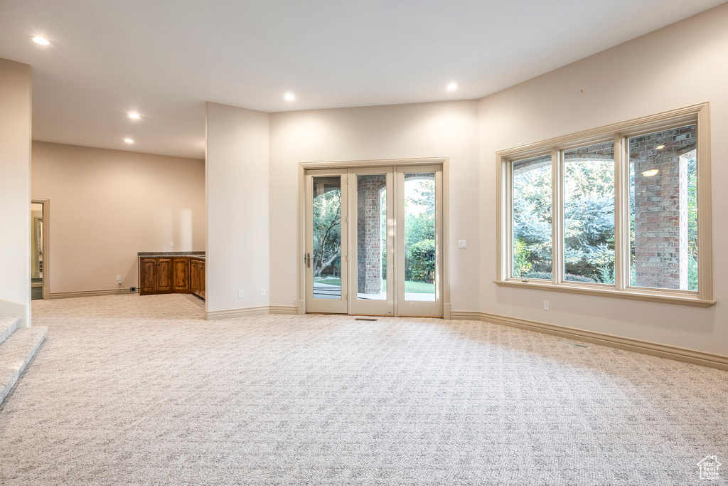 Spare room with recessed lighting and light colored carpet