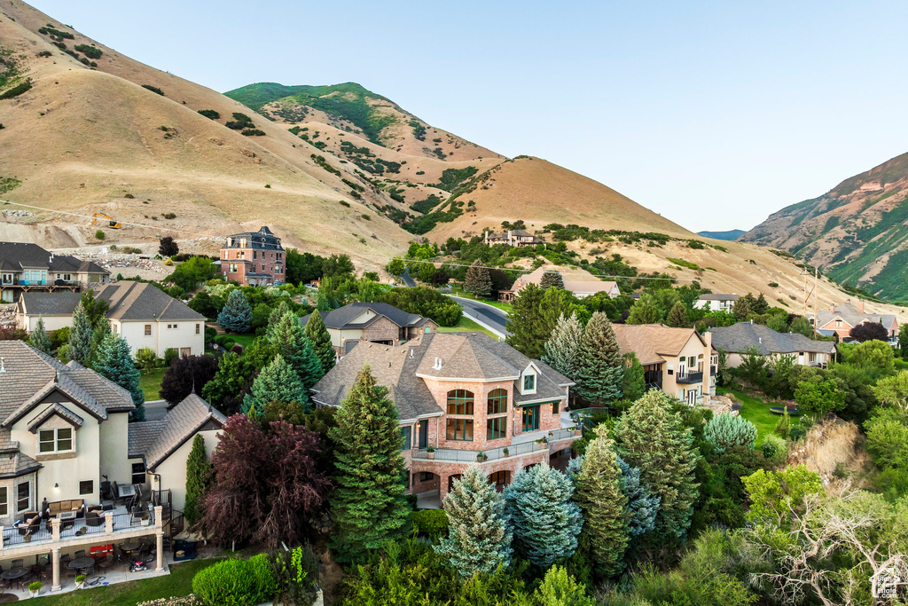View of mountain backdrop featuring nearby suburban area
