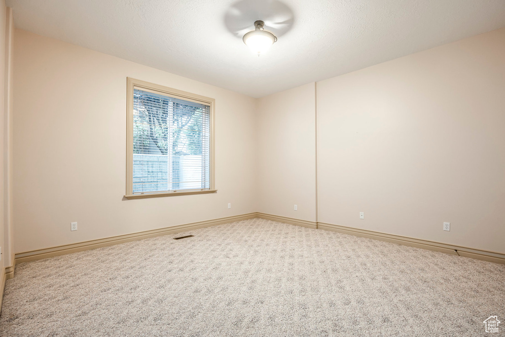 Unfurnished room with carpet floors and baseboards