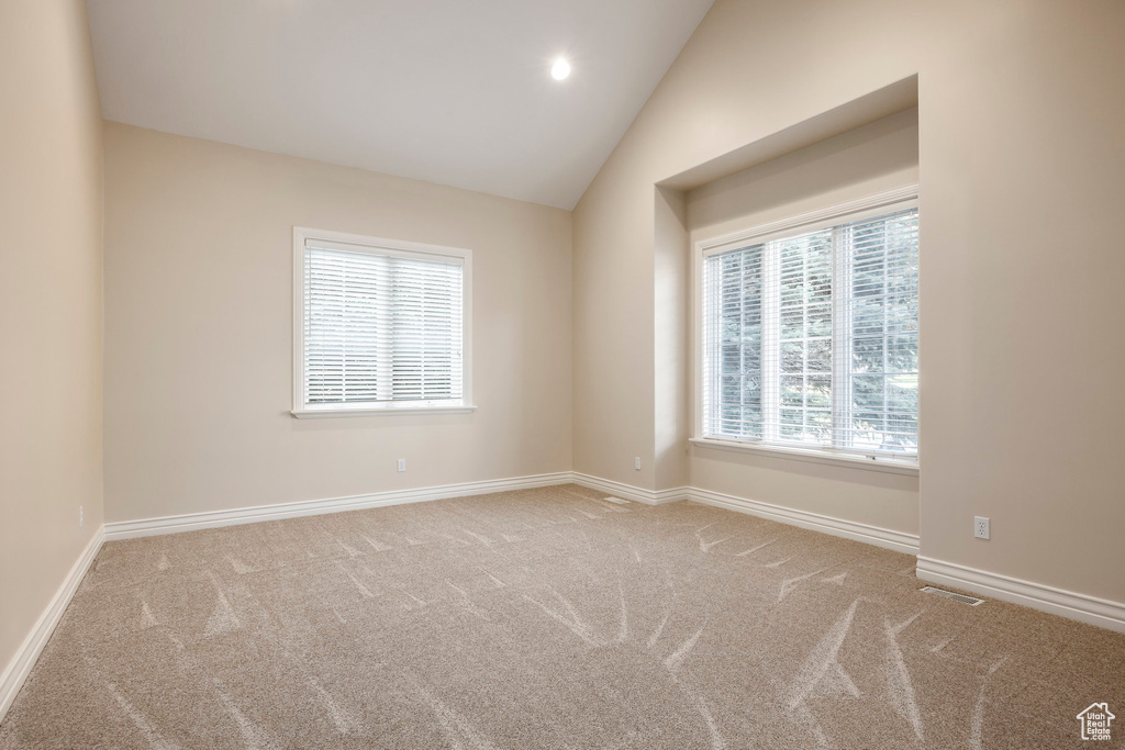 Spare room with carpet flooring, vaulted ceiling, and recessed lighting
