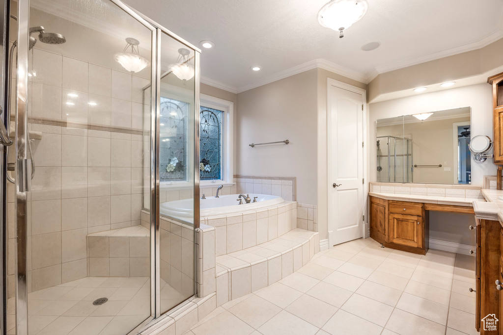 Bathroom featuring vanity, a bath, tile patterned floors, a stall shower, and crown molding