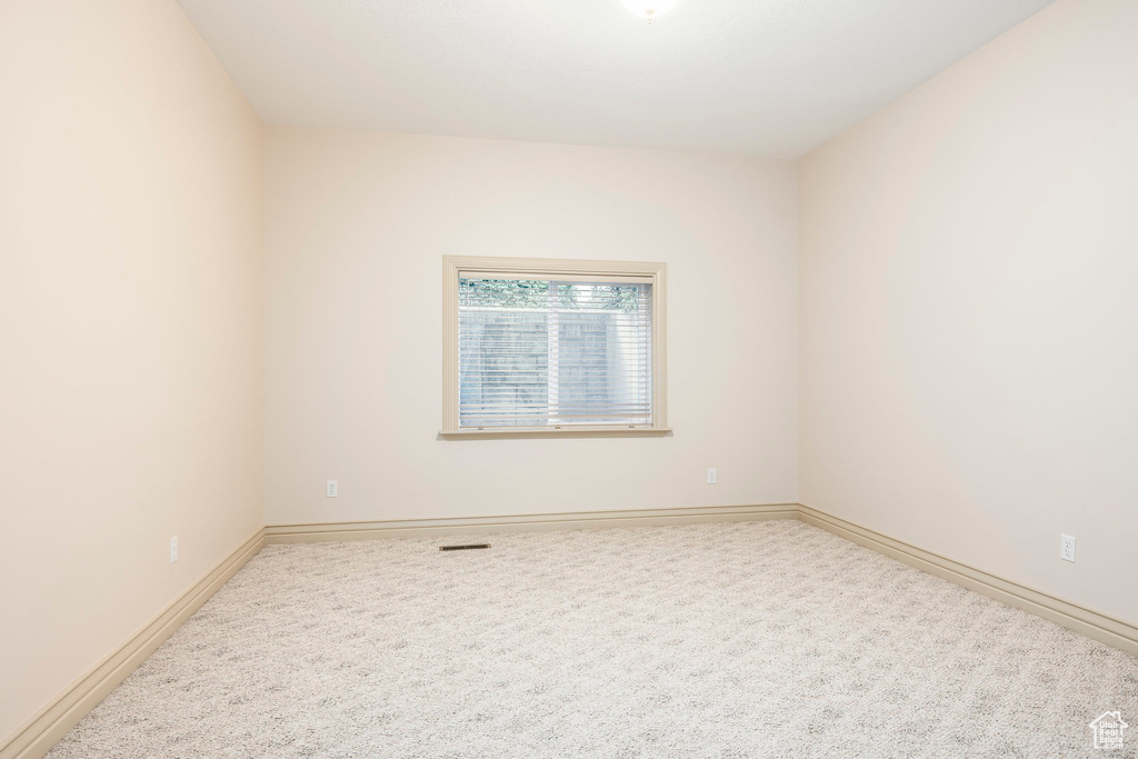 Carpeted empty room with baseboards