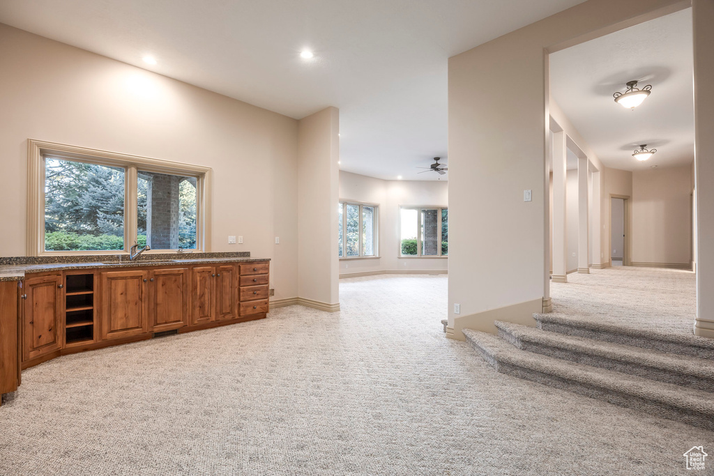 Bar area featuring light carpet, recessed lighting, and ceiling fan