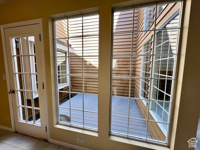 Entryway featuring plenty of natural light and tile patterned flooring