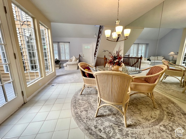 Dining space featuring a chandelier, plenty of natural light, and light tile patterned floors