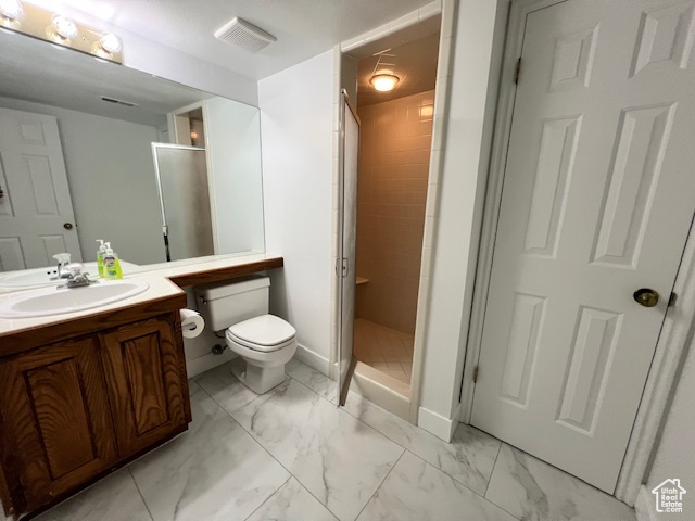 Full bathroom featuring marble finish flooring, vanity, and a shower stall