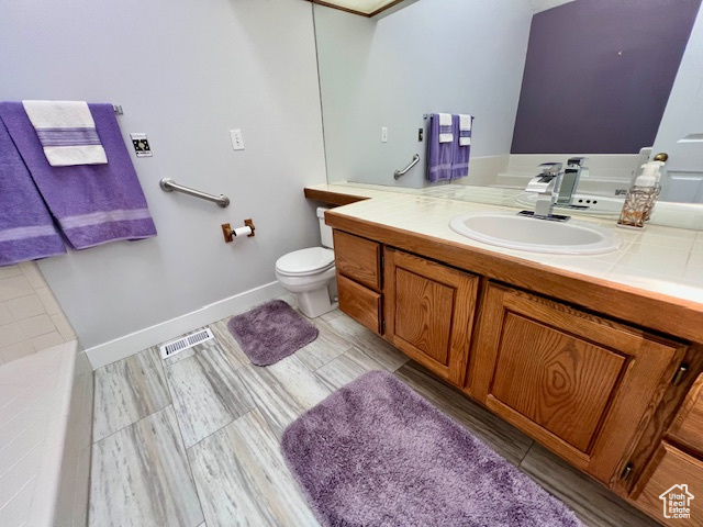 Bathroom featuring vanity and toilet