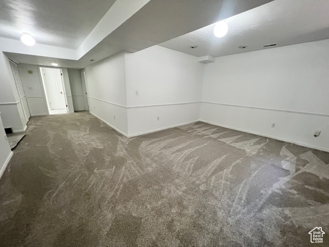 Finished basement featuring carpet and baseboards