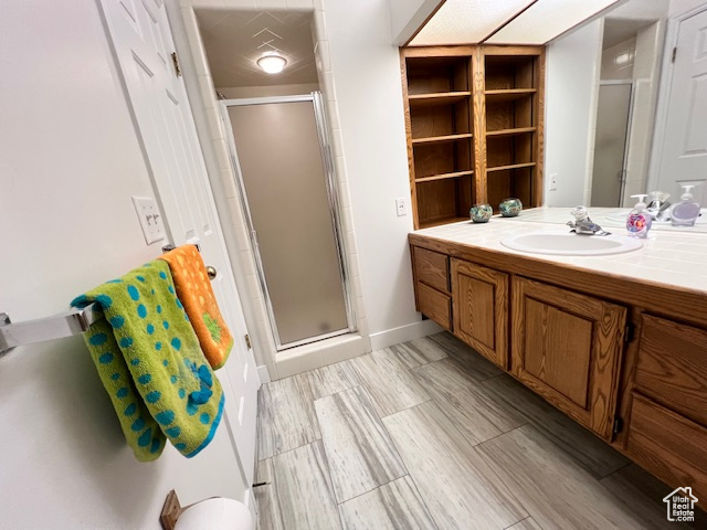 Full bath featuring vanity and a stall shower