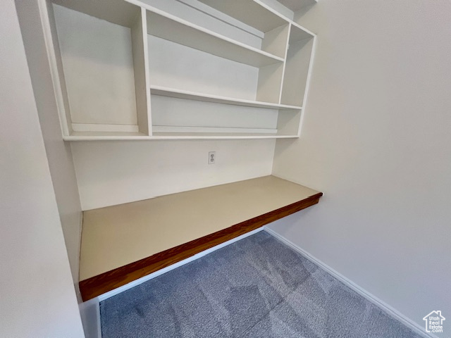 Unfurnished office featuring carpet and baseboards