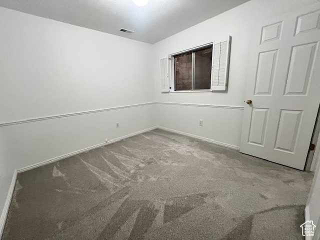 Unfurnished bedroom with carpet floors and baseboards