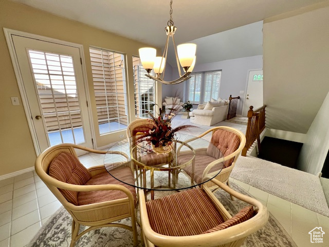 Dining room with a chandelier and tile patterned flooring