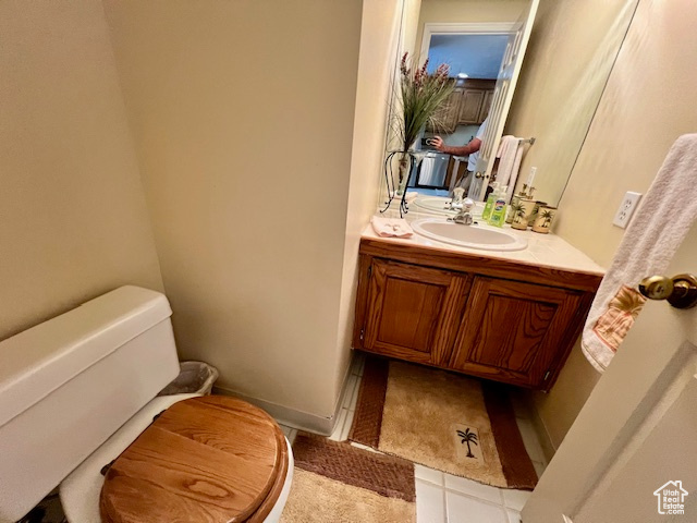 Half bathroom featuring vanity and tile patterned flooring