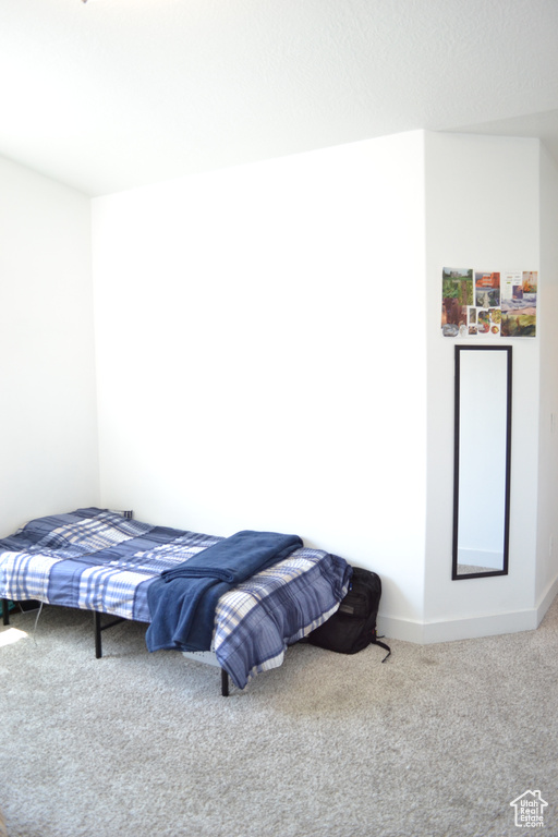 Carpeted bedroom featuring baseboards