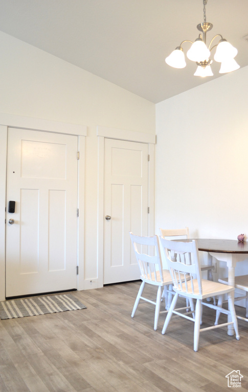 Dining space featuring light wood-style floors and a chandelier