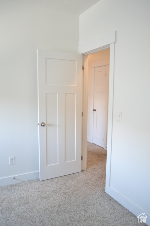 Empty room with carpet floors and baseboards