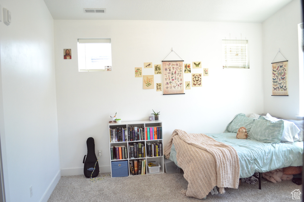 Carpeted bedroom featuring baseboards