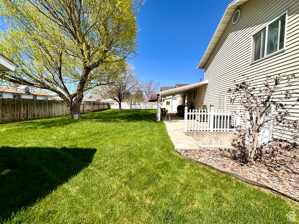 Fenced backyard with a patio area
