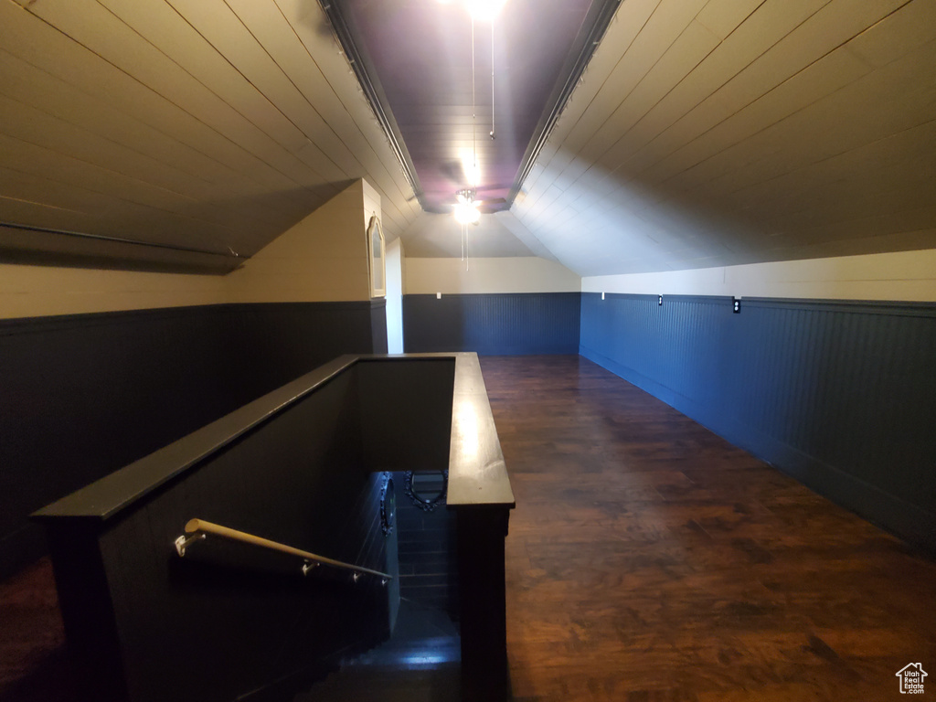Additional living space with wood finished floors and vaulted ceiling