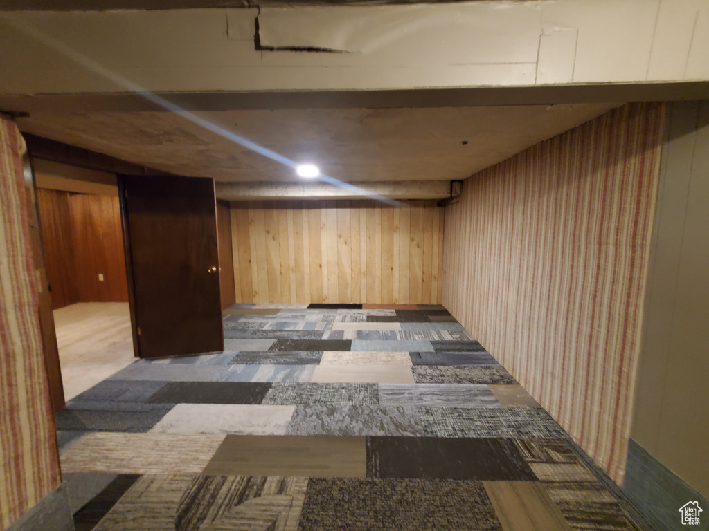 Finished below grade area featuring wood walls