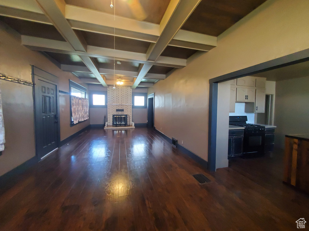 Below grade area with dark wood finished floors and a fireplace