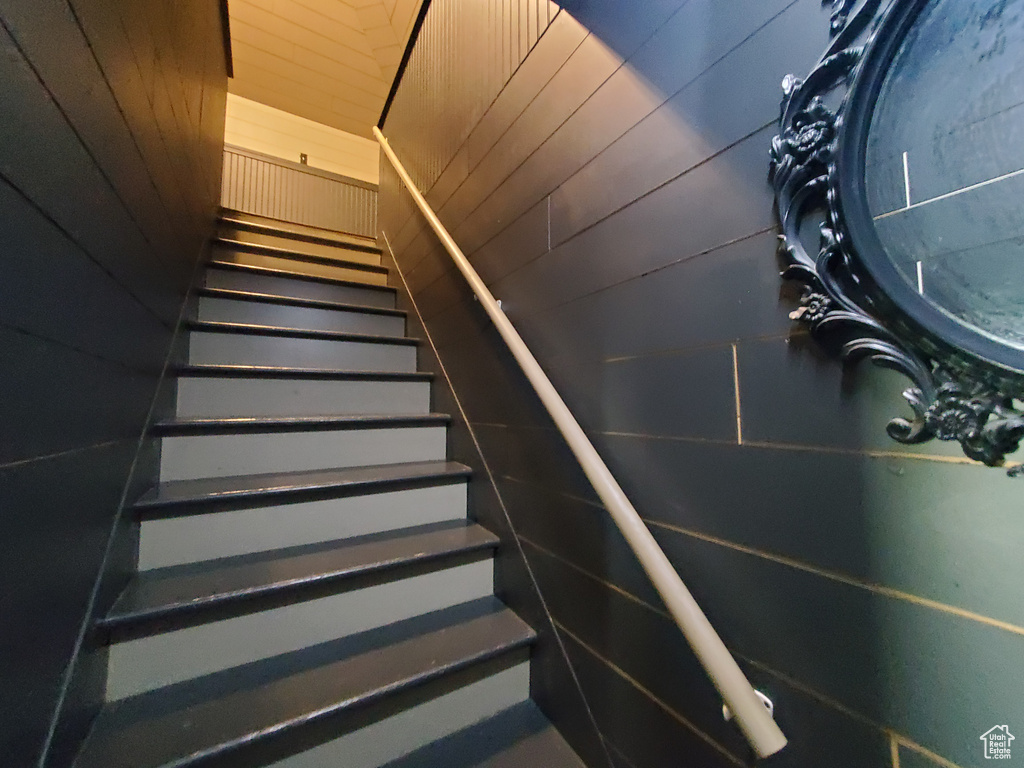 Stairs featuring wood walls